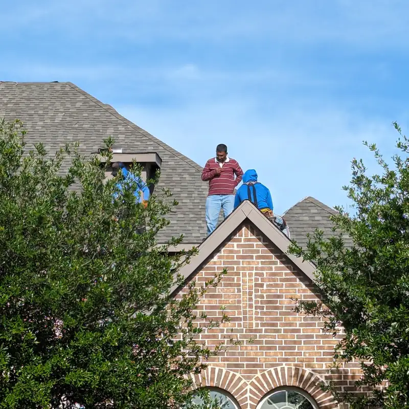A-Roof roofers working on a steep roof in North Texas