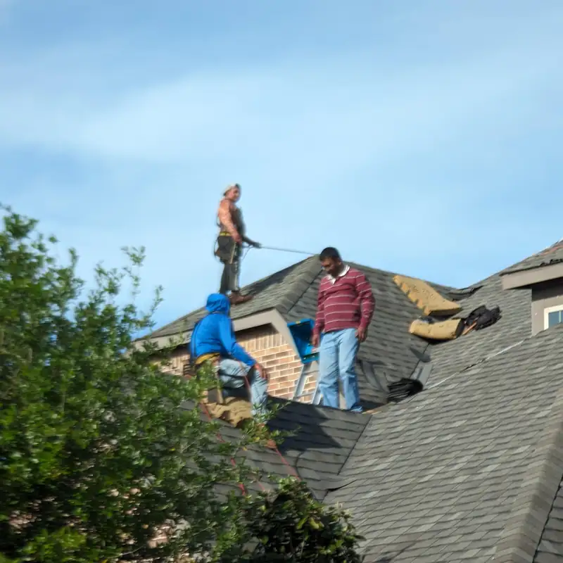 A-Roof crew tearing off old shingles on an Allen-area home